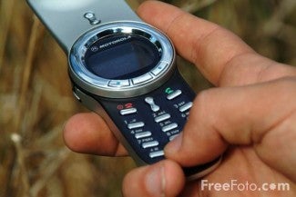 hand pushing cell phone buttons