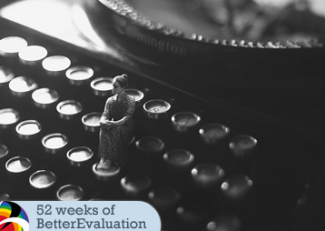 A thumb sized person sits on the key of a typewriter